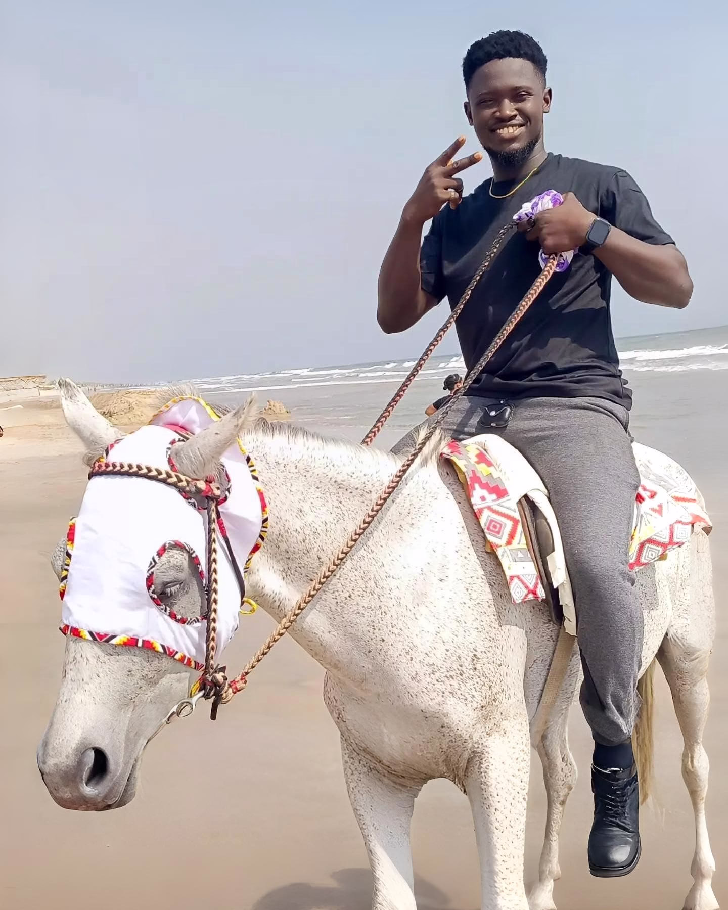 Guy riding horse at the beach