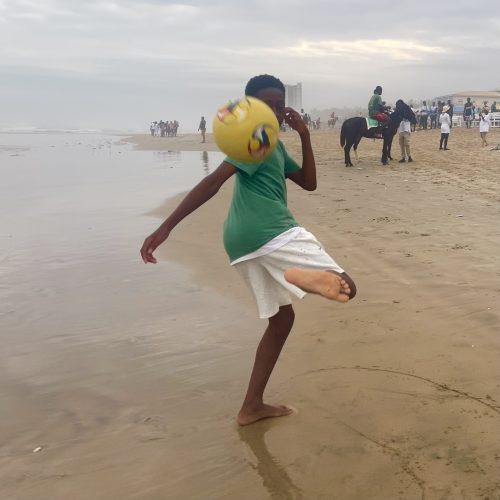 Playing football at the beach